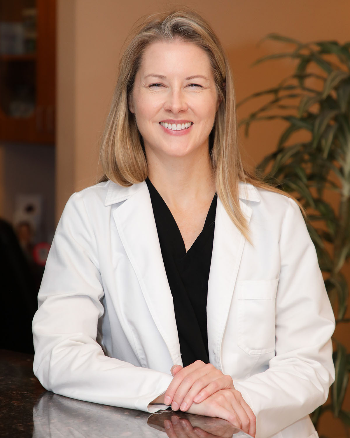 Dr. Diana Craft, DDS, smiling in a white lab coat