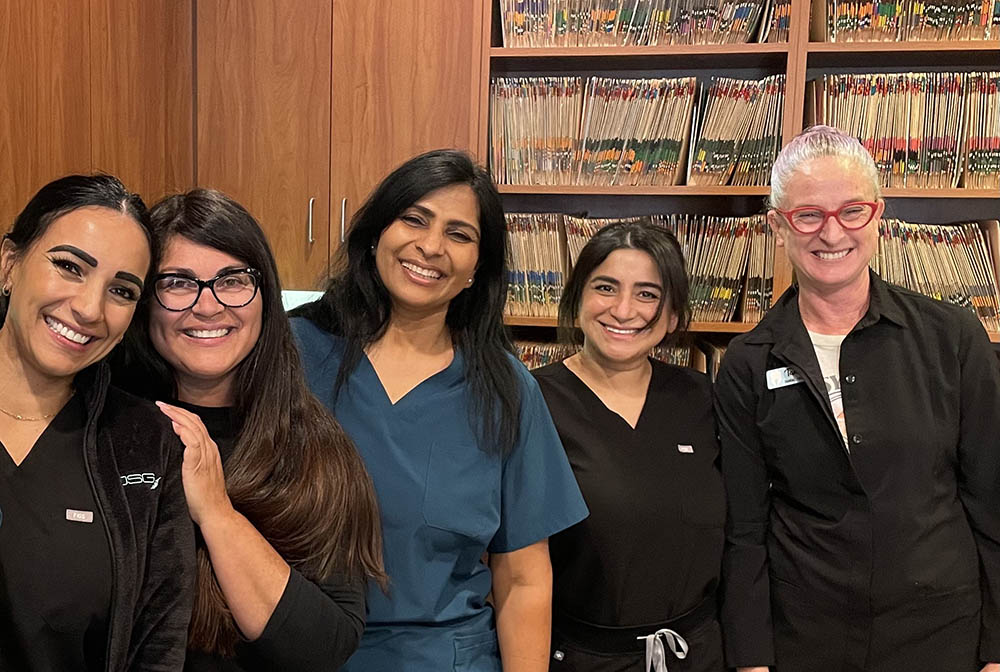 Five Craft Dental team members smiling together in the office