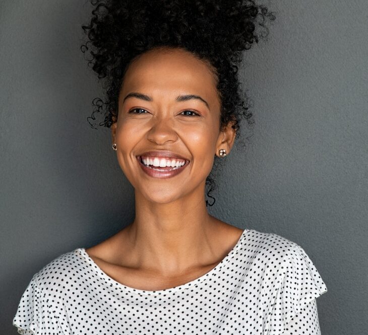 Smiling woman showing radiant teeth after receiving Nitrous Oxide treatment at Craft Dental.