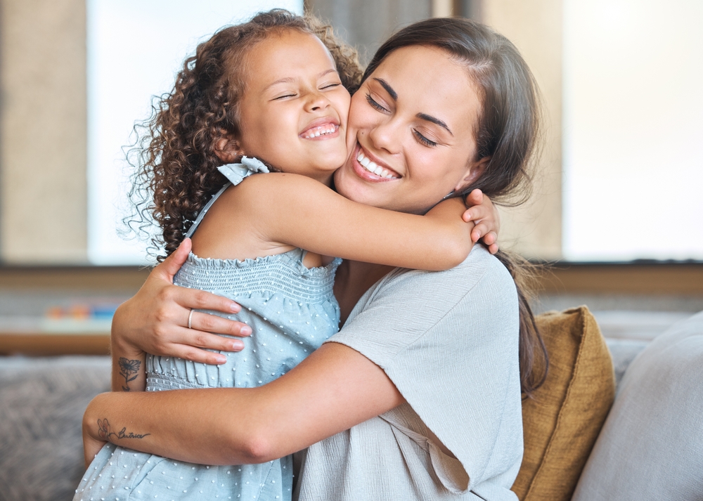 Mother and daughter hugging joyfully, showcasing CraftCare Membership Club benefits at Craft Dental